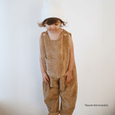 Toddler standing in mustard corduroy baby overalls with relaxed fit